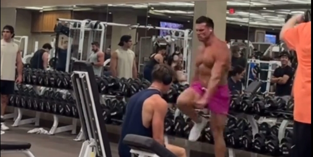 Man performs gym shuffle as bystanders awe in admiration